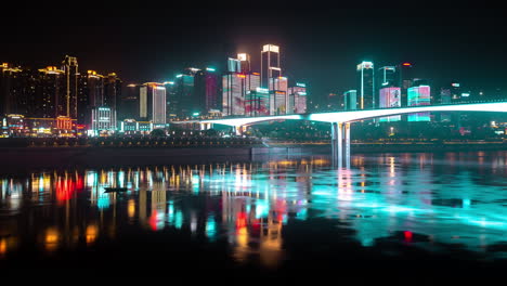 chongqing city china night life flashing vibrant red yellow lights of skyscrapers reflection in river, time lapse