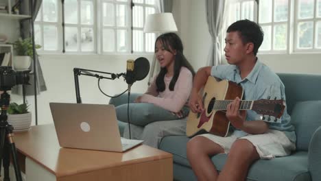 kids singing and playing guitar at home