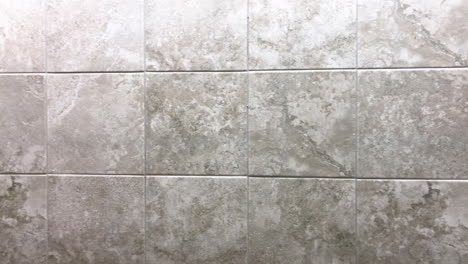 square tiles inside bathroom on wall or floor