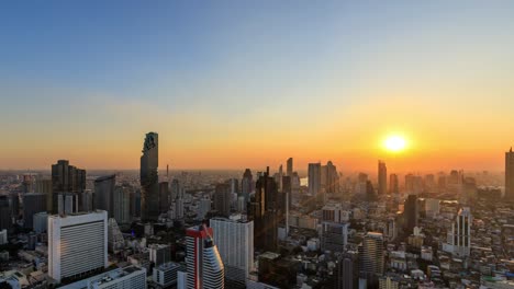 bangkok business district city center above silom area, with buildings and skyscrapers, day to night; zoom in – time lapse