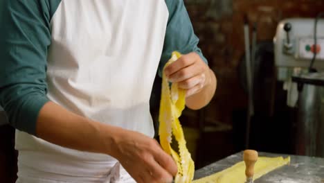 male baker preparing pasta in bakery shop 4k