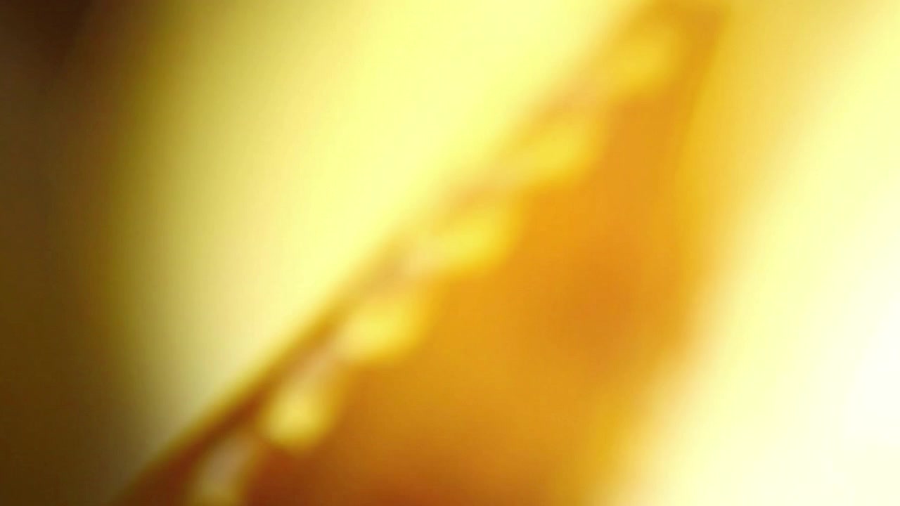 Close-up of 35mm Film Strip Moving Through Light