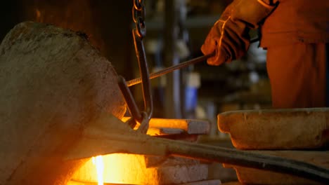 worker pouring molten metal from container in foundry workshop 4k