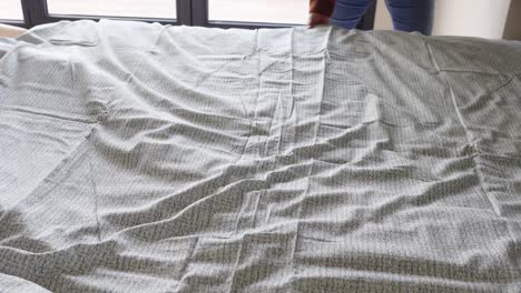 making a bed with patterned sheets