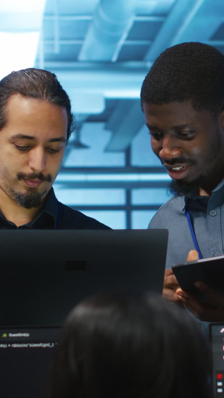 Two Male Developers Collaborating on Code in a Modern Tech Office