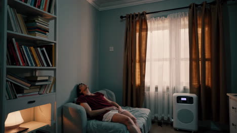 man sleeping on a couch in a cozy room
