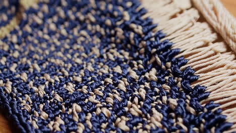 close-up of a woven mat with blue and beige threads