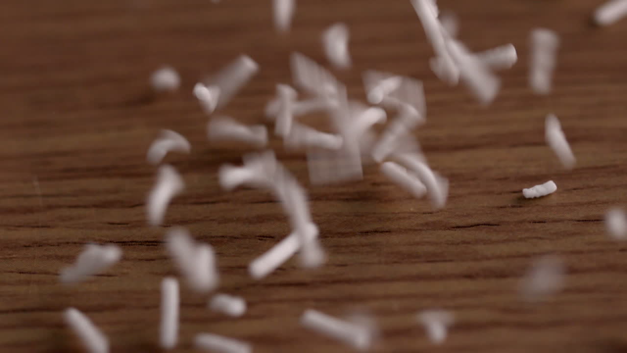 White sprinkles pouring onto surface