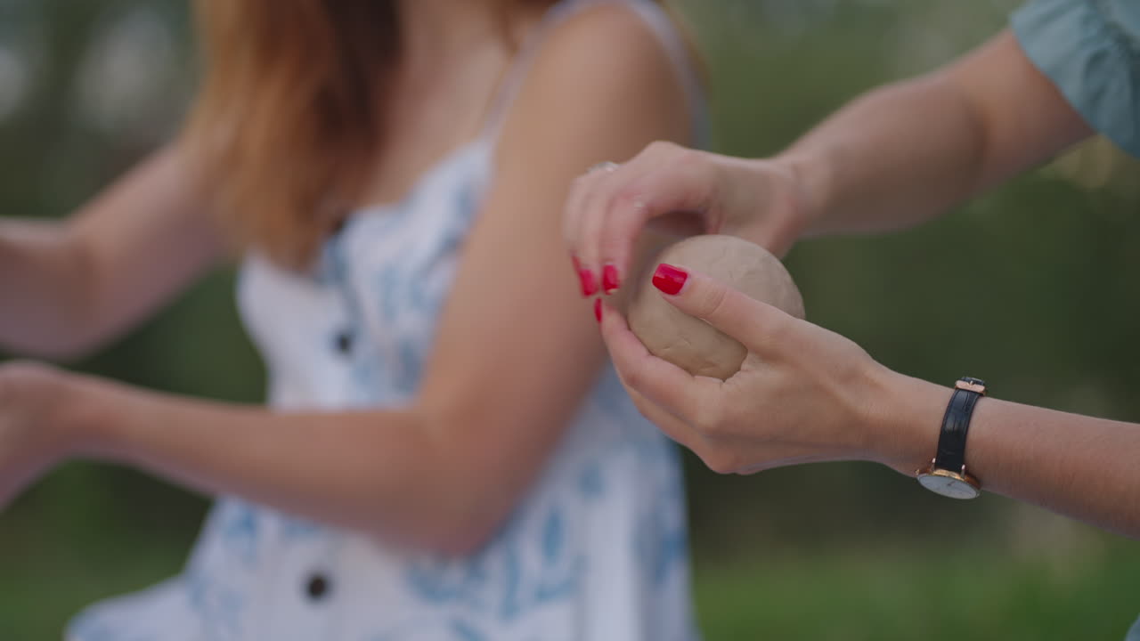 Two young girls are engaged in modeling clay products in nature. Group creative classes women's group classes clay modeling training. Close-up