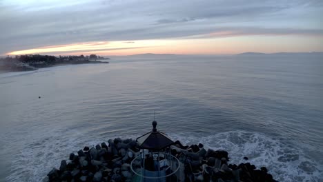 beautiful video of lighthouse symmetrically lined up in the center of the frame just before sunrise