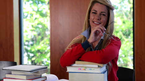 Smiling-mature-student-removing-her-reading-glasses