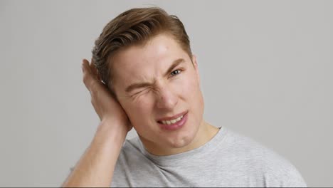 young man experiencing head or ear pain