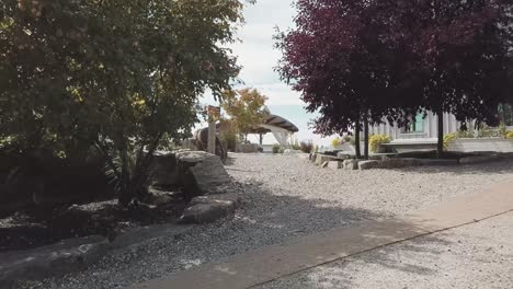 4k-drone-reveal-down-a-rock-garden-path-so-show-a-beautiful-outdoor-wedding-venue-at-Le-Belvédère-in-Wakefield,-Quebec,-Canada