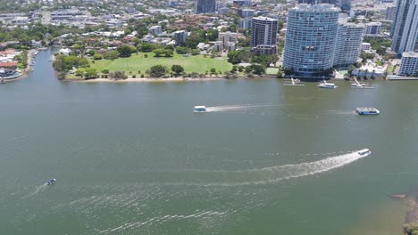 aerial view of ferry navigating urban river