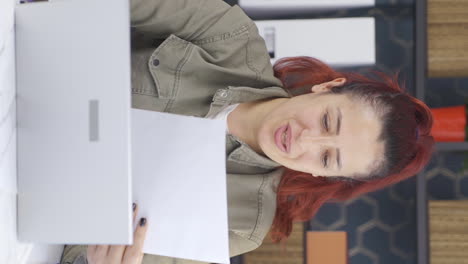 vertical video of business woman rejoicing at positive paperwork results.