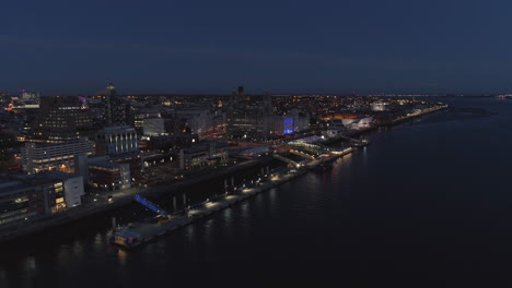 river mersey, river of light, liverpool, england. night time. drone flys forward and tilts down. 4k