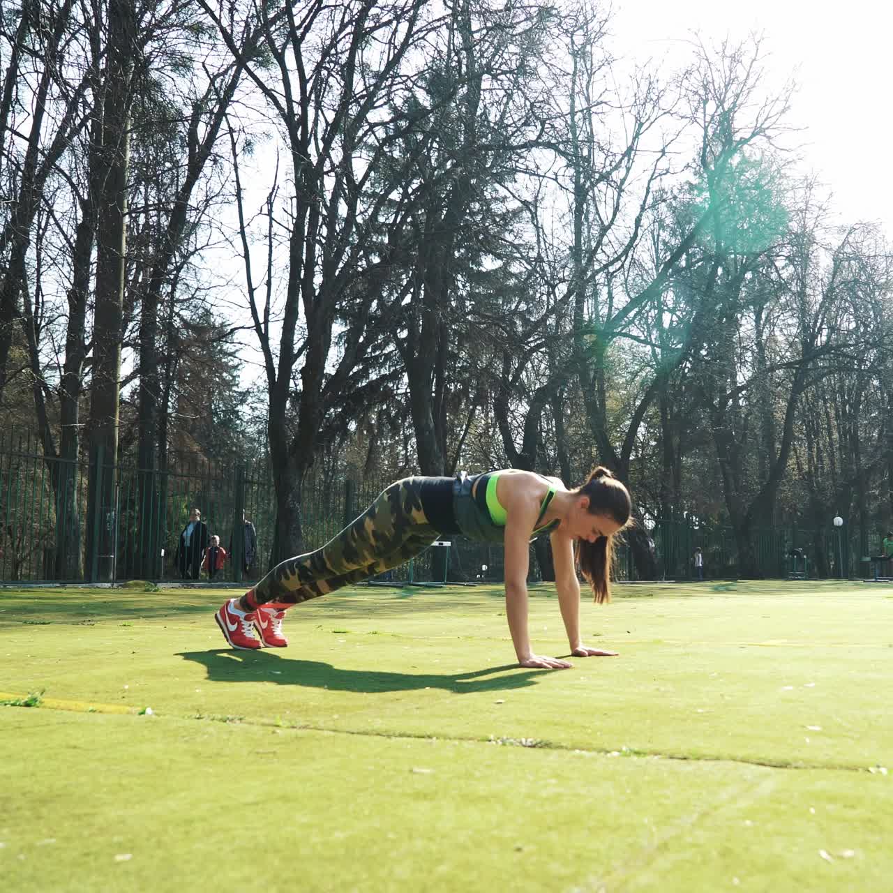 Young woman lying on the ground is stretching her legs after running. Athletic girl working with elastic band