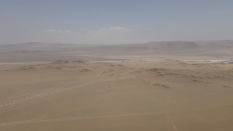 Aerial-view-of-empty-desert-Pacific-coastline-sand-in-central-Peru