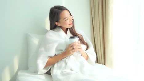 Beautiful-Happy-Exotic-Woman-in-Bathrobe-Having-Morning-Coffee-by-Window,-Full-Frame