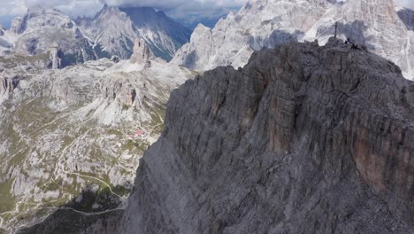 spectacular mountain view of ferrata de luca innerkofler and monte paterno in italy - tilt up drone view