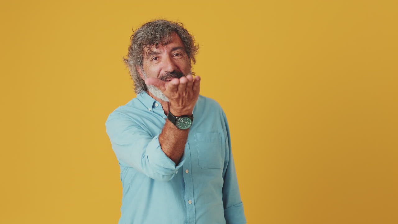 Happy Mature Man Blowing a Kiss and Smiling