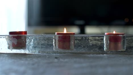 front view of three scented candles on a table in the house