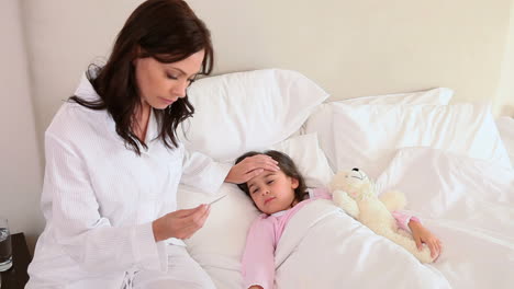 sick little girl lying in a bed