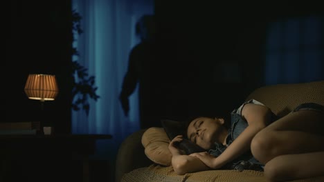 young girl sleeping on sofa at home, frowning from nightmare