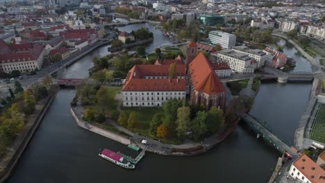 Epic-aerial-view-of-Roman-church-on-Odra-river-in-Wroclaw-city-at-day-time