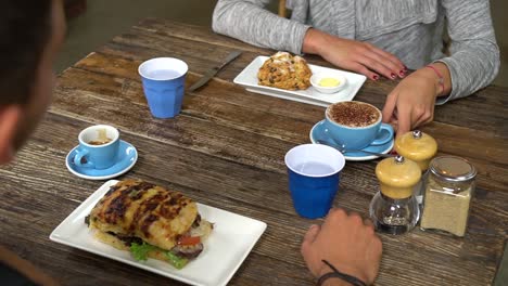 SLOWMO---Young-couple-having-coffee-and-breakfast-at-stylish-cafe