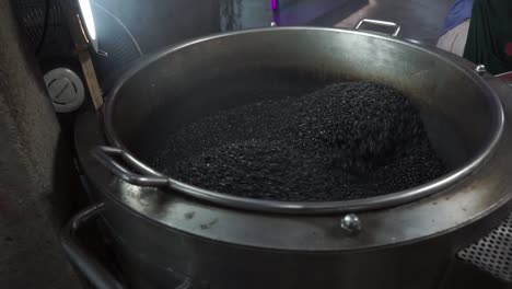 black sesame seeds in a grinding machine
