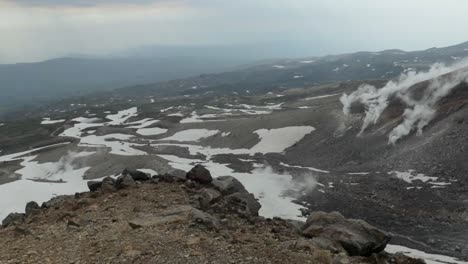 hot steam geysers on mountain slope of active volcano mount asahidake in japan
