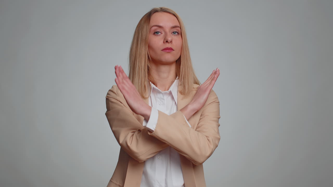 Woman say no hold palm folded crossed hands in stop gesture warning of finish prohibited access