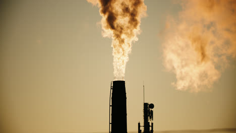 industrial factory pipes silhouette emitting air pollution smoke into atmosphere