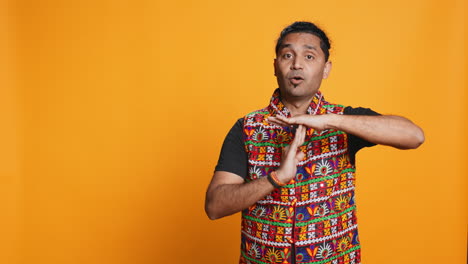 firm person doing vehement pause sign gesturing, studio background