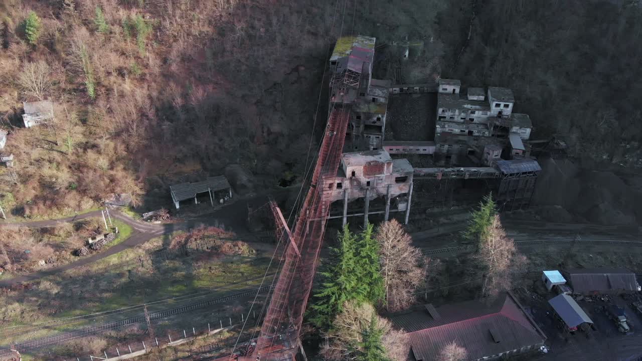 Aerial footage of factory using cableways to transport mined goods