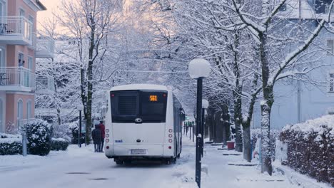 urban city life with people and vehicle commuting on snow covered roads during extreme winters