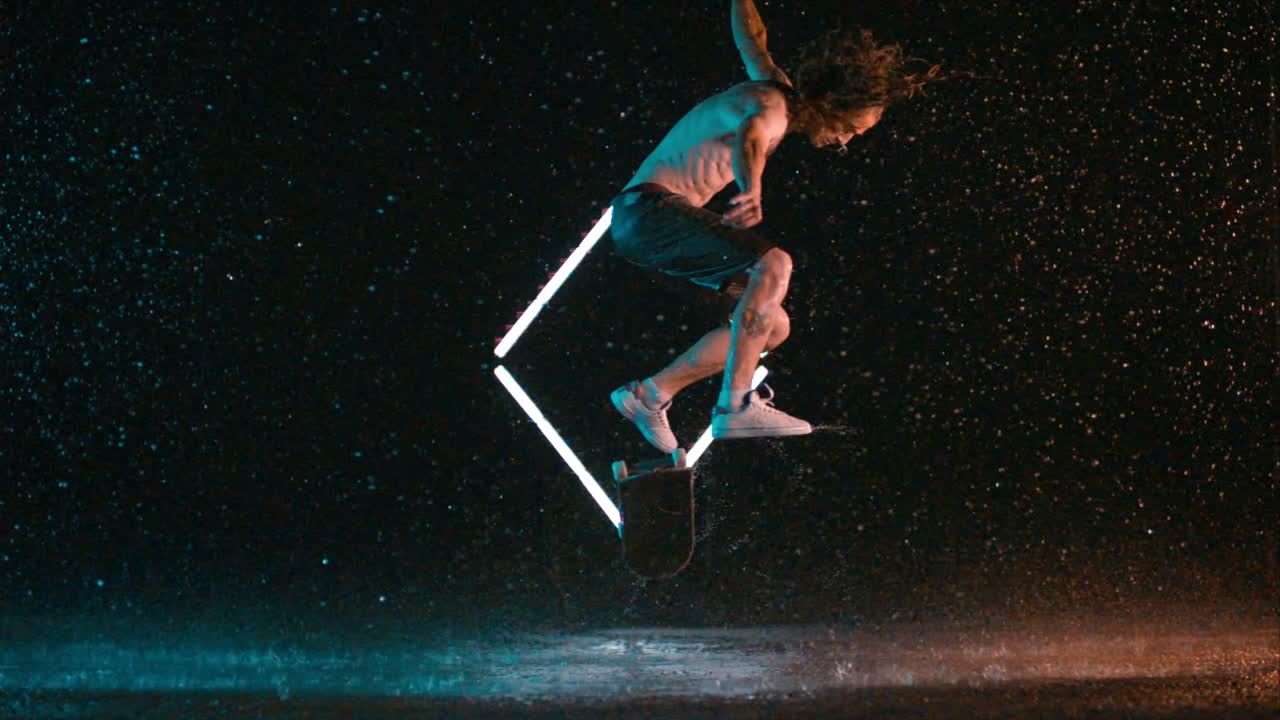 Awesome Skateboard Kickflip trick in wet rain studio, super slow motion, caucasian man