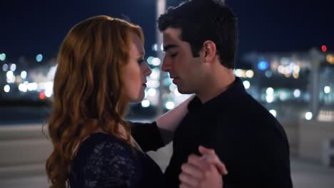 a romantic dance under the stars: captivating moments shared between two souls in a dazzling nighttime setting of lights and connection