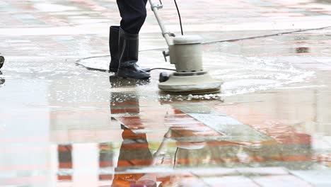 man using industrial floor cleaning machine