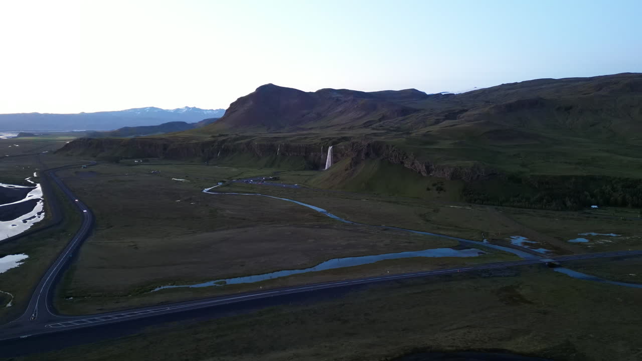 Hringvegur 1 With Seljalandsfoss Waterfall In The Distance In Iceland. - aerial shot
