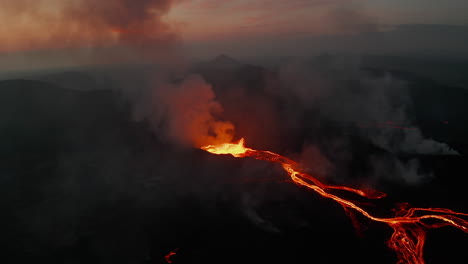 Backwards-reveal-of-branching-lava-stream-flowing-down-on-volcano-slope.-Crater-of-active-volcano-in-twilight-time.-Fagradalsfjall-volcano.-Iceland,-2021