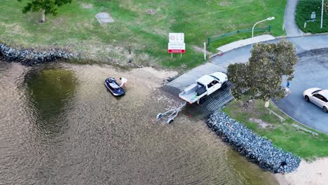 drone captures a boat being launched at a ramp in gold coast, australia, with clear skies and calm waters