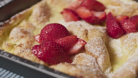 a panakuken with strawberries and powdered sugar - close up