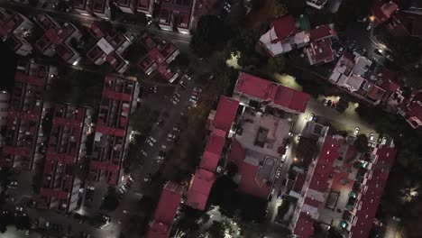 Drone-flies-over-residential-complexes,-Coyoacan,-Mexico-City-at-night