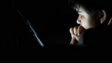 child using a tablet at night