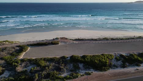 A-sporty-person-cycling-close-to-the-beach-at-sunset-in-the-Esperance-Area-of-Western-Australia