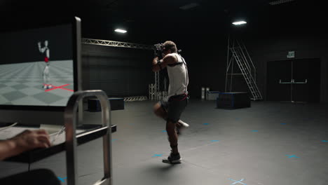 man wearing motion capture suit in studio performing martial arts actor boxing wearing mo-cap suit for 3d character computer game animation for virtual reality fighting gaming