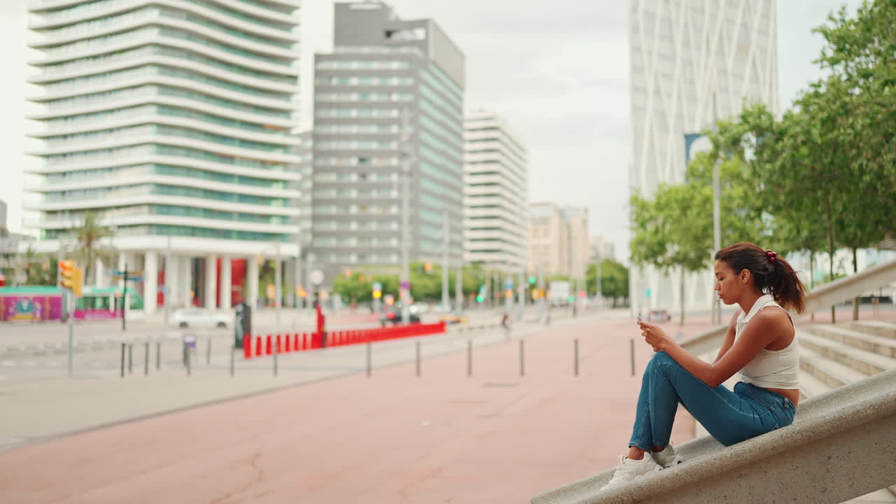 Woman sitting on stairs in an urban setting