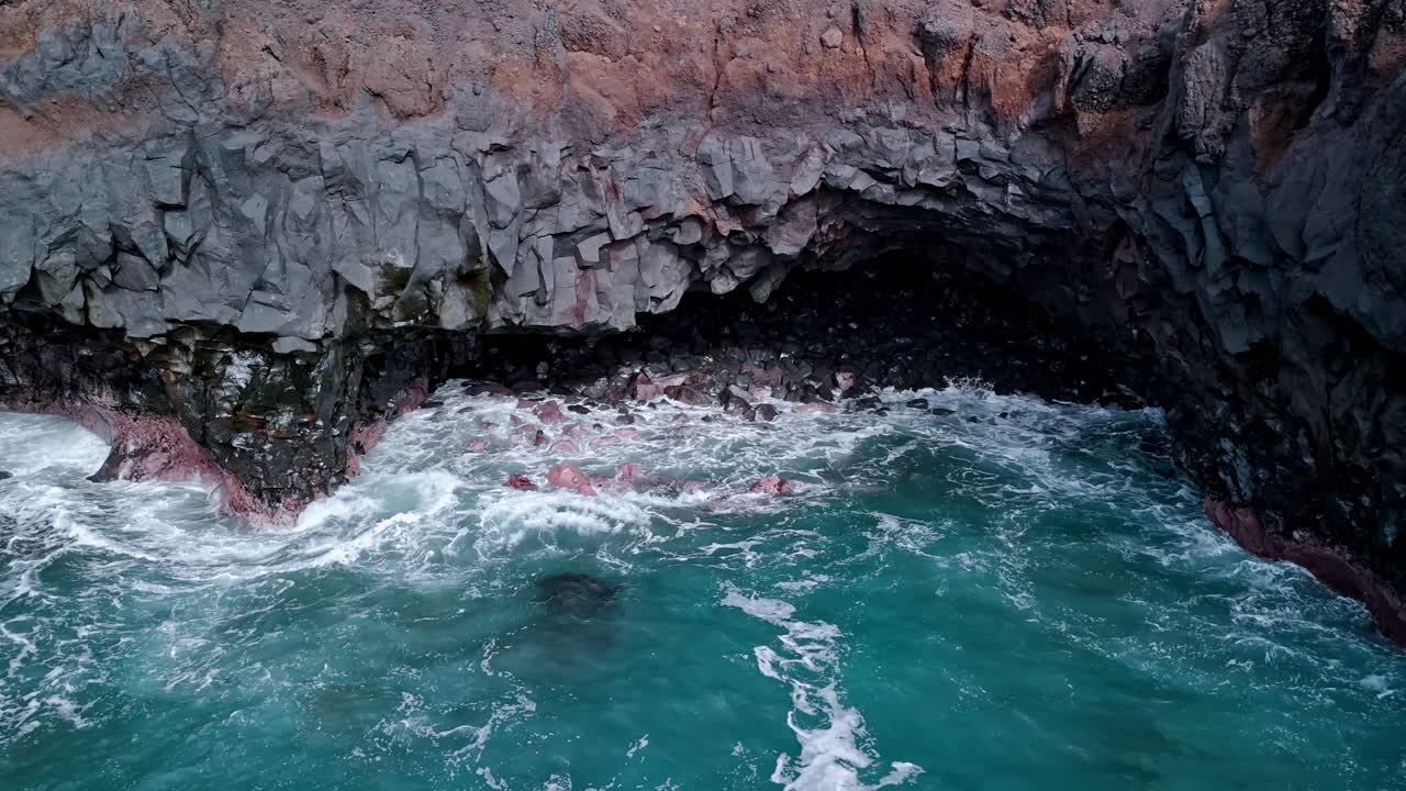 Powerful ocean waves crash violently into the volcanic cliffs of Los Hervideros in Lanzarote, Canary Islands, Spain.